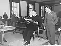 Polish priest Theodore Korcz (left) reads from the Malaria protocols on 22&nbsp;November 1945