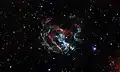 Featured in this Hubble image is an expanding, gaseous corpse — a supernova remnant — known as 1E 0102.2-7219.[3]