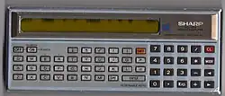 Sharp PC-1211. This example exhibits a display that is failing, a very common problem with Sharp's displays of the time.