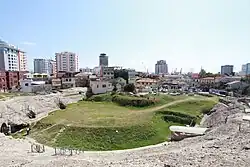 The amphitheatre of the city of Durrës and its port in the background.
