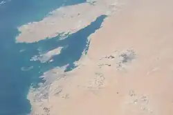 View from the International Space Station of the Gulf of Bahrain, facing southeast, with Qatar visible at top, and Bahrain Island off it
