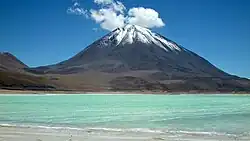 Licancabur, against a blue sky across the Laguna Verde salt lake