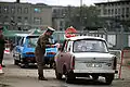 An East German policeman monitors traffic returning to East Berlin through the newly created opening in the Berlin Wall at Potsdamer Platz on 14 November 1989.