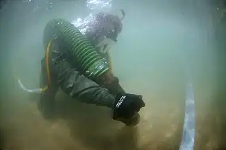 Removing sediment with a suction pump
