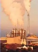 Steam plumes from industrial sources.