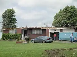 EF2 damage example--Well-built structures can suffer serious damage, including roof loss, and the collapse of some exterior walls may occur in poorly built structures. Mobile homes, however, are destroyed. Vehicles can be lifted off the ground, and lighter objects can become small missiles, causing damage outside of the tornado's main path. Wooded areas have a large percentage of their trees snapped or uprooted.