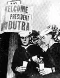 Americans greet Dutra with a gesture of welcome.