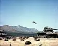 M712 Copperhead, a laser guided artillery shell, approaches a target tank