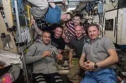 The newly-expanded six-member Expedition 57 crew poses for a portrait inside the International Space Station's Zvezda service module on December 10, 2018