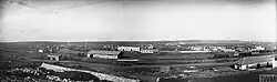 Panorama photo of groups of trains and buildings