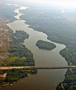Aerial view looking east, of Rivière des Prairies with Louis Bisson Bridge in the foreground. The island "Ile aux Chats" can be seen near the centre.
