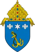 The arms of the Archdiocese of Anchorage: The anchor references the namesake of the see, Anchorage, Alaska.