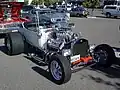 T-bucket with early hemi, but aluminum radiator (rather than brass), rectangular headlights, and five-spokes (rather than motorcycle wheels) mark this as a later incarnation