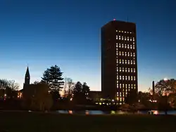 A large, rectangular tower with various trees